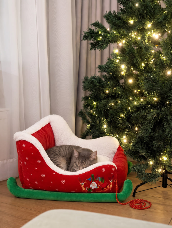 Tabby cat asleep in the Mistletoe Sleigh bed
